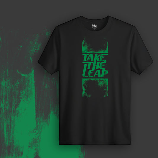 Take The Leap T-Shirt (Black) - Features bold, high-impact typography framed in a raw brushstroke style, signaling action and movement.