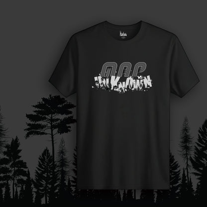 Map vs Unknown T-Shirt (Black) - Features fragmented “Map vs Unknown” text layered over a silhouetted forest landscape, creating a raw and rebellious aesthetic.